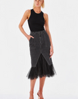 Black denim midi skirt by Le Superbe, featuring high-waist, front pockets, center slit, and black tulle hem.