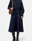CLOSED Midi Zip Skirt in denim, featuring an asymmetrical front zipper, styled with a matching shirt and suede bag.