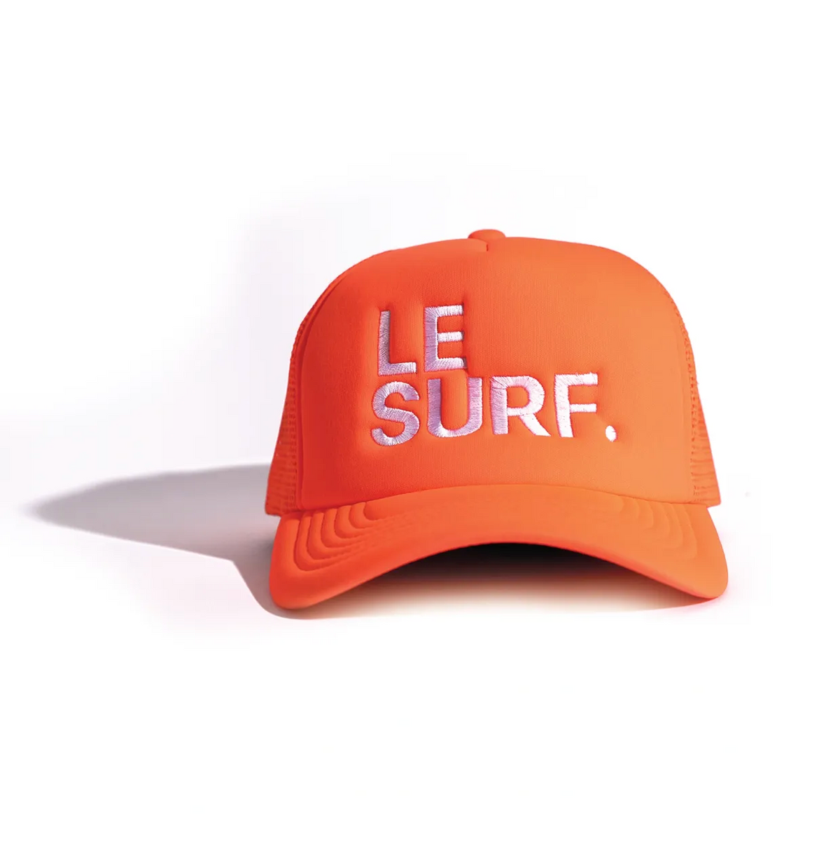 The Ping Pong Surf Club Le Surf Hat is an orange mesh trucker cap with white mesh sides and "LE SURF." in crisp white embroidery on the front, shown on a white background.