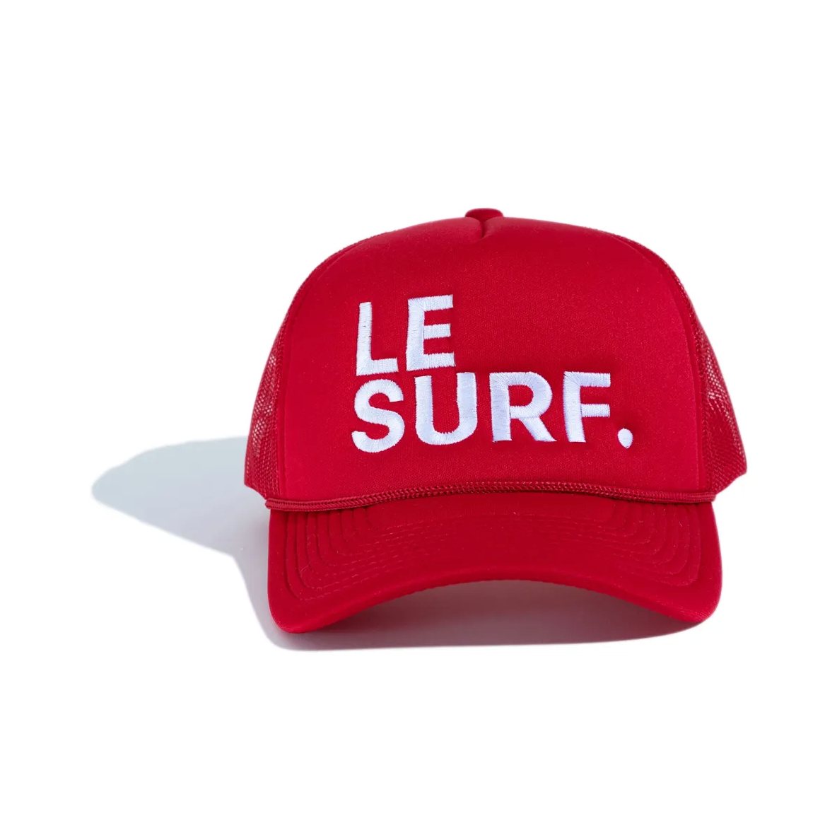 The Le Surf Hat by Ping Pong Surf Club is a red mesh snapback with "LE SURF." embroidered in white on the front, shown against a white background.