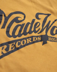 The Pocket Tee MadeWorn Records by Made Worn is a yellow vintage unisex tee made in the USA from 100% cotton, featuring "MadeWorn RECORDS HOLLYWOOD, CA." printed boldly on the pocket.