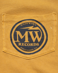 The Made Worn Pocket Tee MadeWorn Records is a 100% cotton, unisex vintage-style tee made in the USA, featuring a mustard yellow denim pocket with a blue circular "MADEWORN MW RECORDS HOLLYWOOD, CA" logo.
