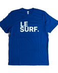 The Le Surf Tee by Ping Pong Surf Club is a royal blue unisex cotton t-shirt with bold white “LE SURF.” text and the classic Le Surf logo, shown on a plain white background.