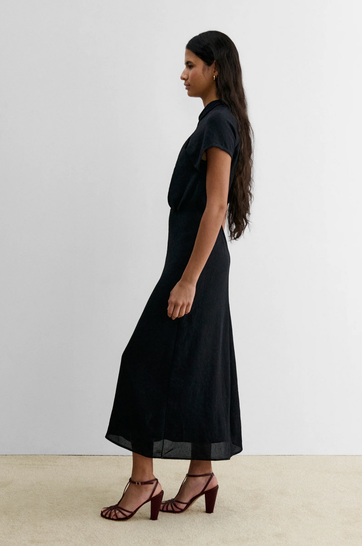 Rachel Comey Pout Dress in soft blush with maroon heeled sandals, styled in a modern, minimal interior setting.