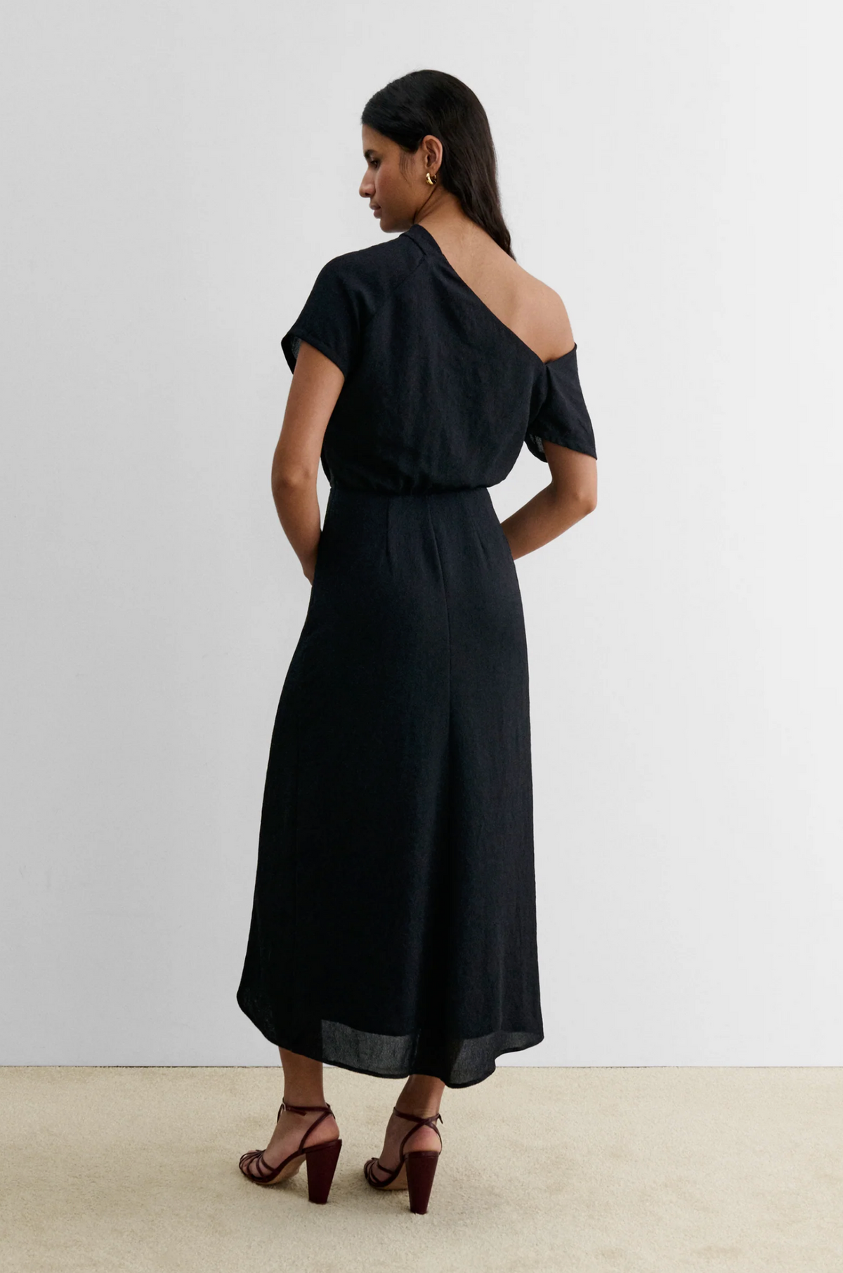Black Rachel Comey Pout Dress styled with maroon heels, shown from the back against a neutral background.