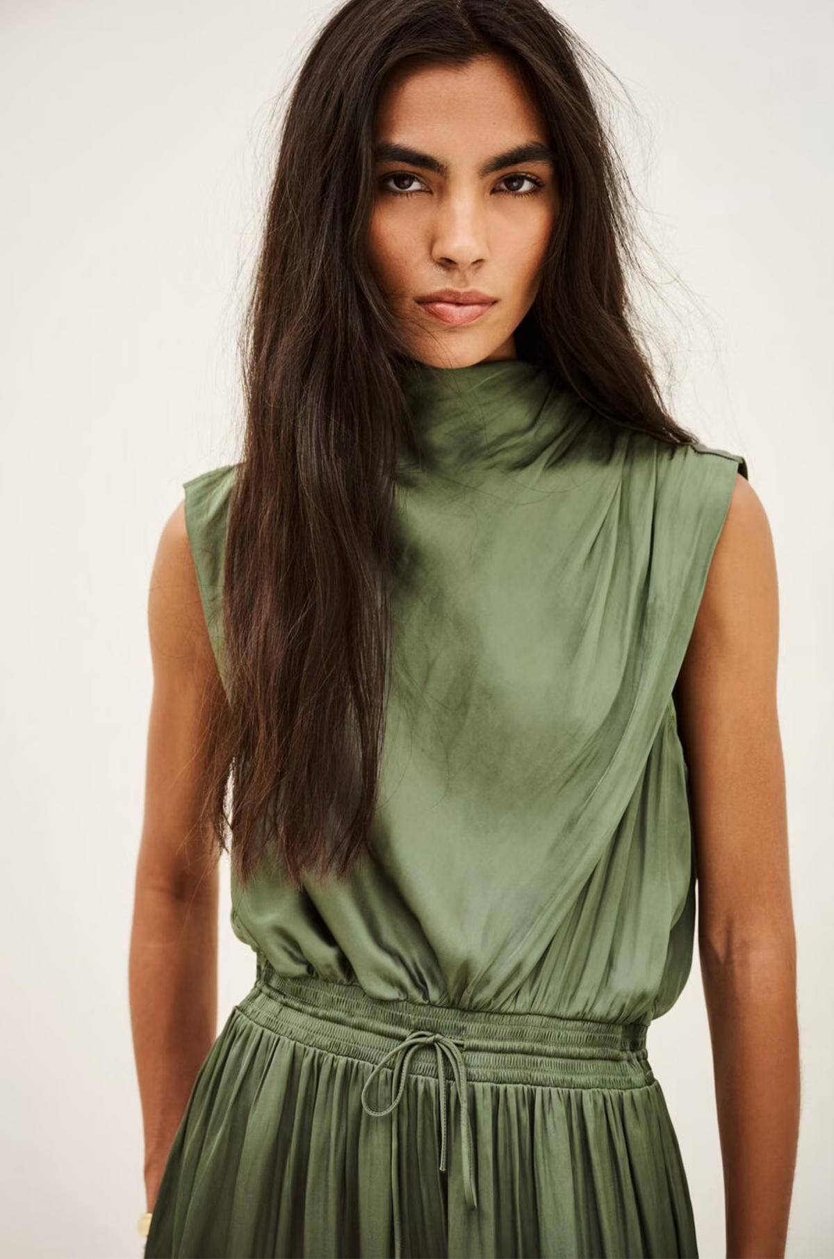 BA&SH Celea sleeveless olive green satin midi dress modeled with confidence, showcased for Bungalow Furniture & Accessories.