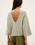 Light gray mohair-alpaca V-neck cardigan with deep V-back by BA&SH, styled with olive pants.