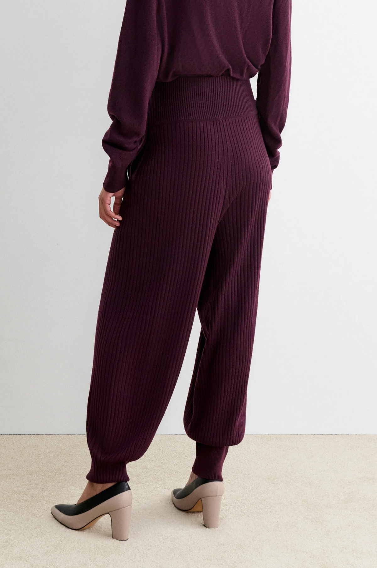 Rachel Comey Nim Pant and matching sweater in beige, styled with heels on a light carpet for a cozy look.