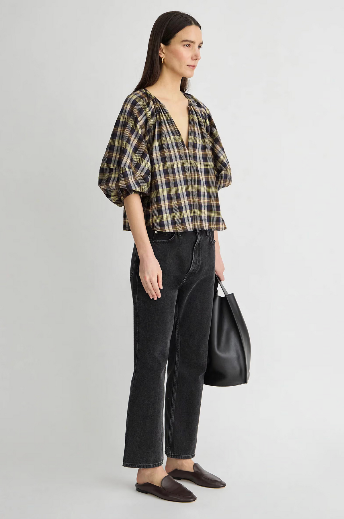 Apiece Apart Nele Lantern Sleeve Top styled with black jeans and loafers, casual modern look, side profile view.