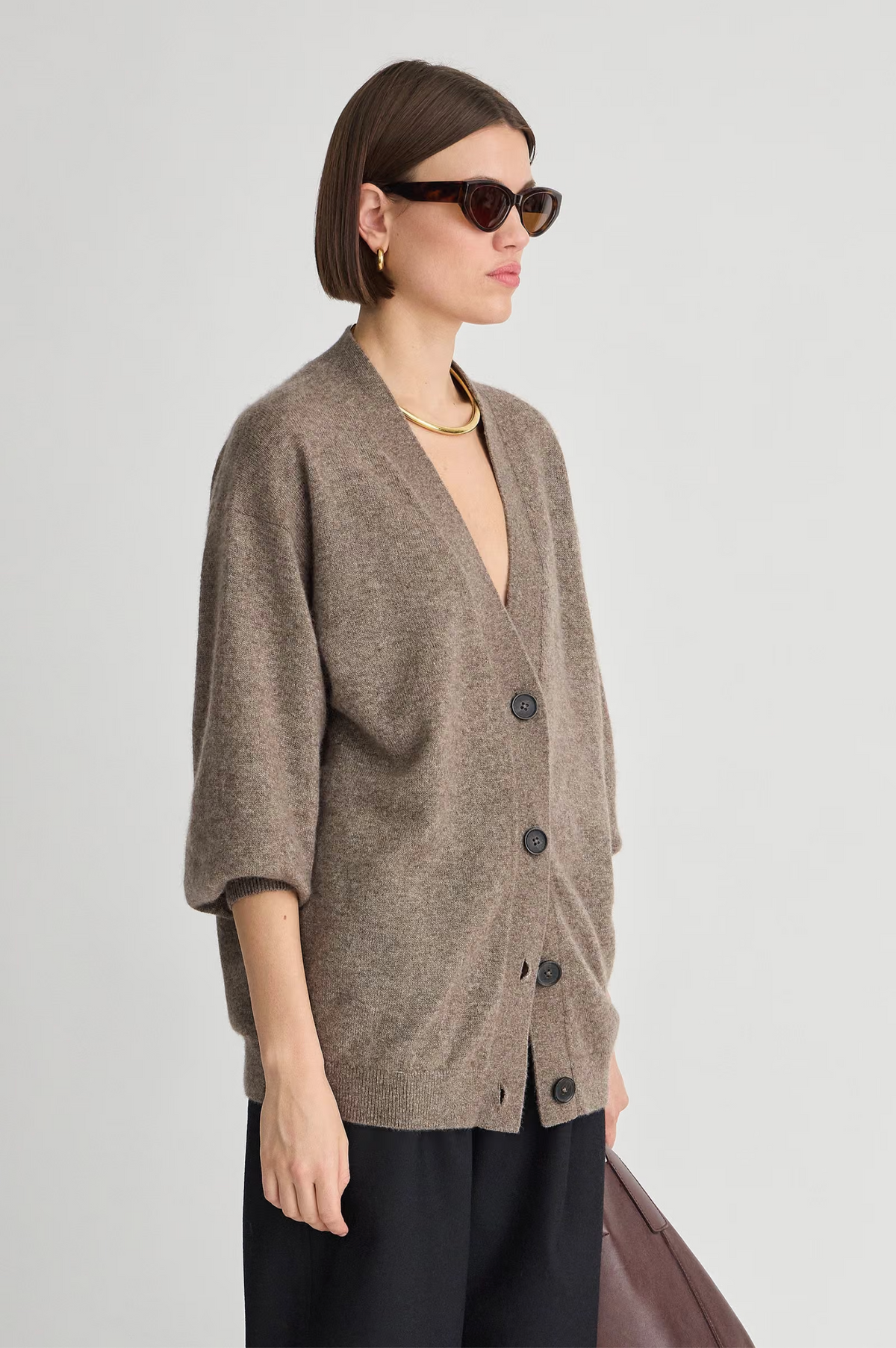 Soft knit Apiece Apart cardigan styled with sunglasses and gold jewelry, Bungalow Furniture & Accessories.
