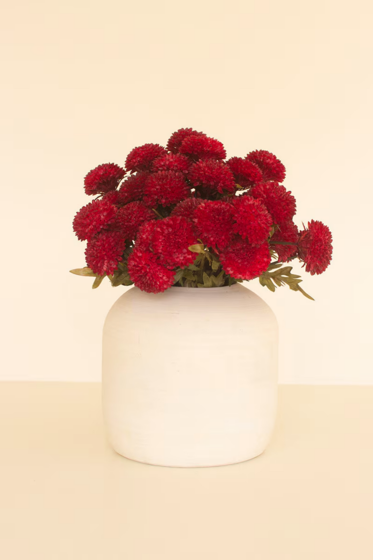 Red Dahlia vase with vibrant blooms by Kalalou, Inc. on a beige background, available at Bungalow Furniture & Accessories.