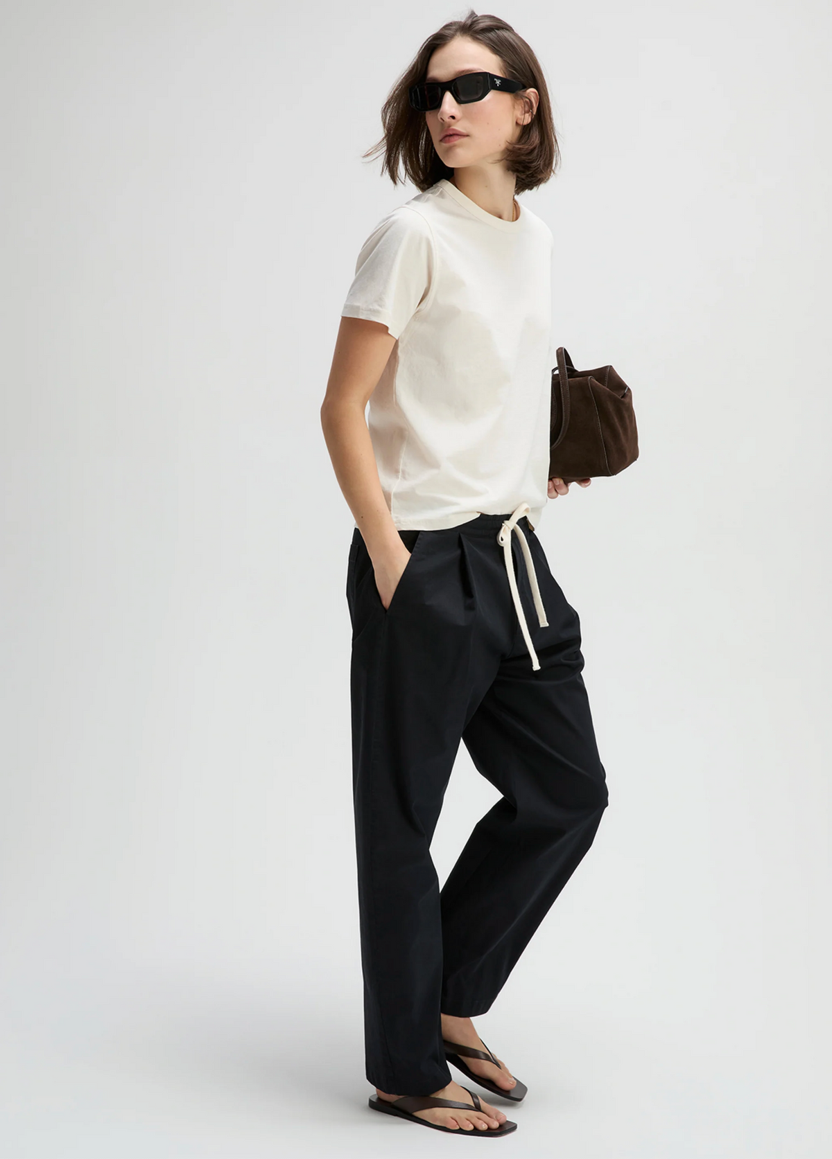Cream Perfect Tee by Sold Out NYC styled with casual drawstring pants and flip-flops in a relaxed, sunny setting.
