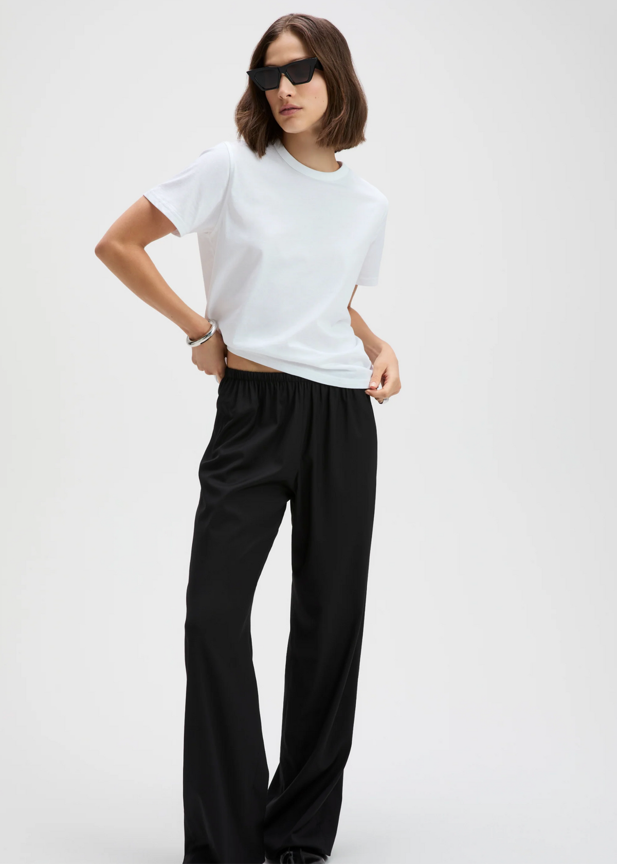 White Perfect Tee by Sold Out NYC styled with black pants and sunglasses for a modern, relaxed look.