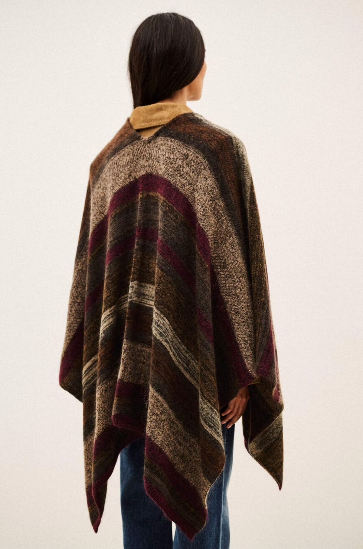 BA&SH Poncho Perros with brown, beige, and burgundy stripes, shown from the back on model with long dark hair.