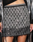 Black and white geometric sequin A-line mini skirt with a fringed hem by Le Superbe.
