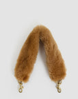 Tan shearling Shortie Strap by Clare Vivier with gold-tone swivel clasps and leather attachment.