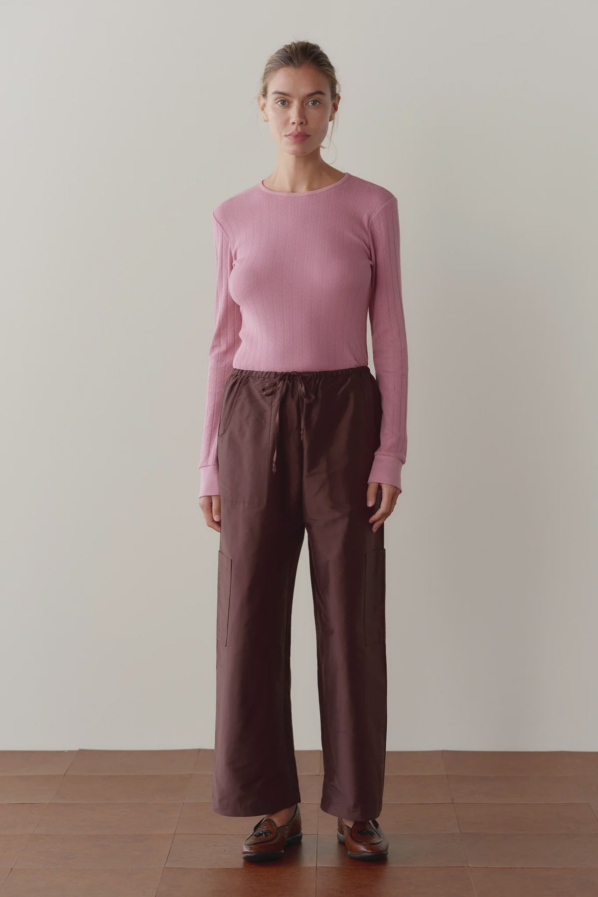 The Taffeta Drawstring Cargo Pant in brown paired with a long-sleeve pink ribbed top.