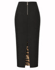 Le Superbe Jet Set Liza midi skirt in black with a front zipper, scattered studs, and a visible leopard print lining.