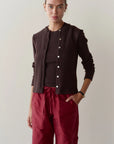 The Sweater Rib Cardi in dark brown worn with a matching sleeveless top and red drawstring pants.