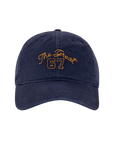 The Baseball Hat by The Great Inc. is a navy blue cap with vintage embroidery, featuring "The Great 67" in yellow on the front and an adjustable strap, displayed on a plain white background.