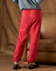 The Fleece Stadium Sweatpant in bright red French Terry with gathered cuffs styled with brown loafers.