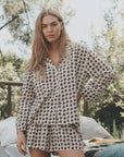 Long-sleeved button-down shirt and The Flannel Smocked Sleep Short with bear pattern from Bungalow Furniture & Accessories.
