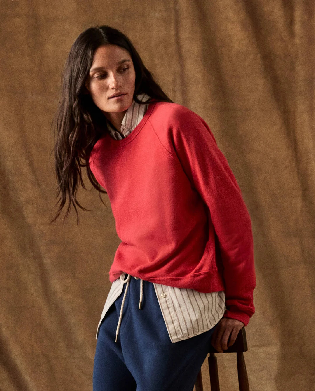 The Fleece Rookie Sweatshirt layered over a striped button-down shirt.