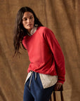 The Fleece Rookie Sweatshirt layered over a striped button-down shirt.