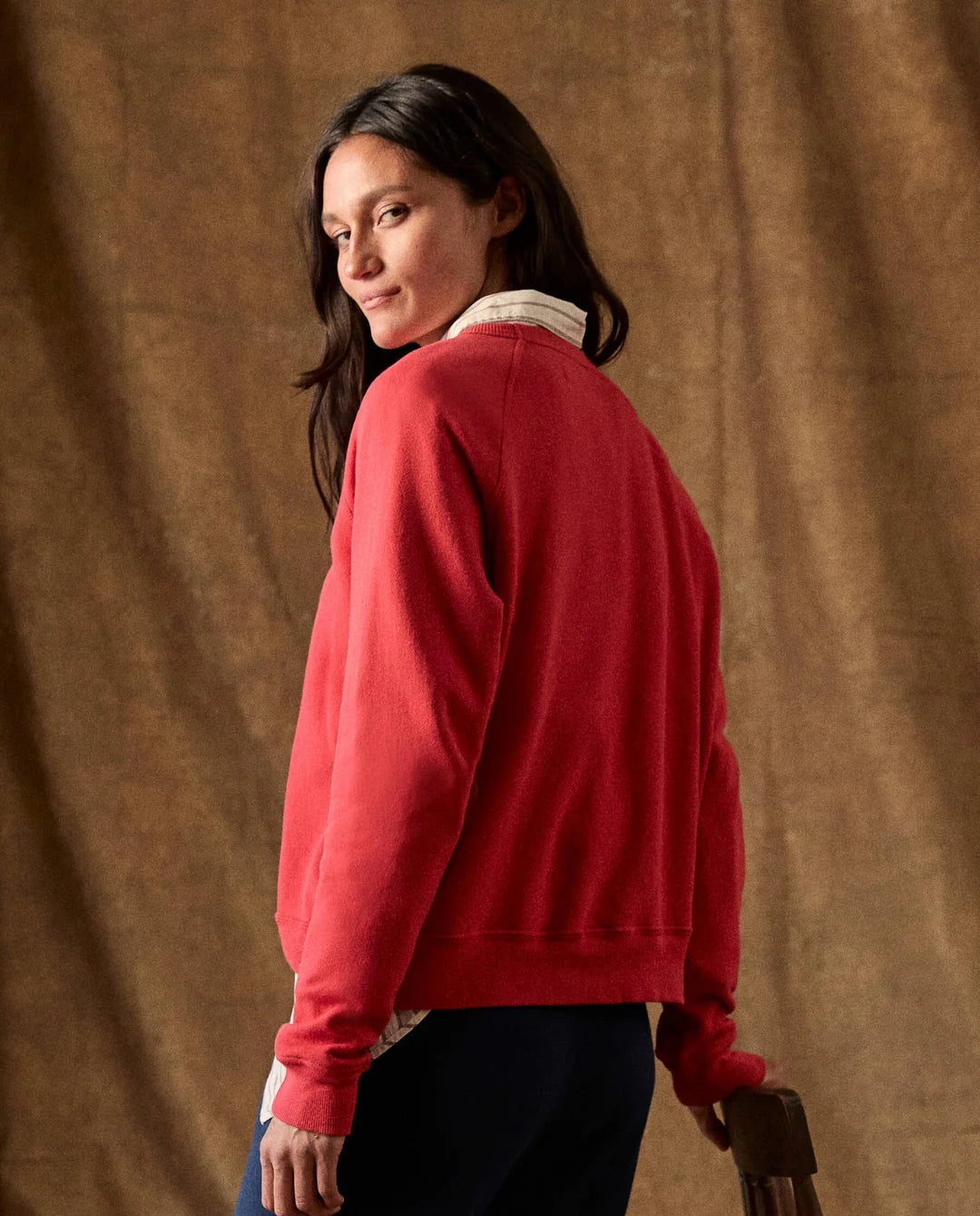 Red Fleece Rookie Sweatshirt worn over a striped collared shirt.
