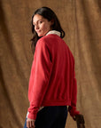Red Fleece Rookie Sweatshirt worn over a striped collared shirt.