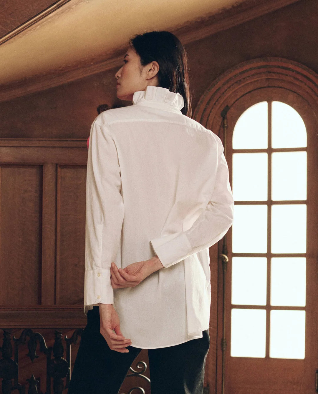 Oversized The Ruffle Neck Shirt with vintage ruffle detail, worn by a person facing away.