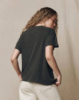 Vintage striped The Boxy Crew tee by The Great Inc. styled with beige pants, model shown from the back.