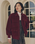 Burgundy The Great Inc. Patch Pocket Plush Jacket layered over a white turtleneck and patterned dress.