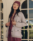 Lurex Commander Riding Cardi worn over a maroon patterned shirt with matching headscarf.