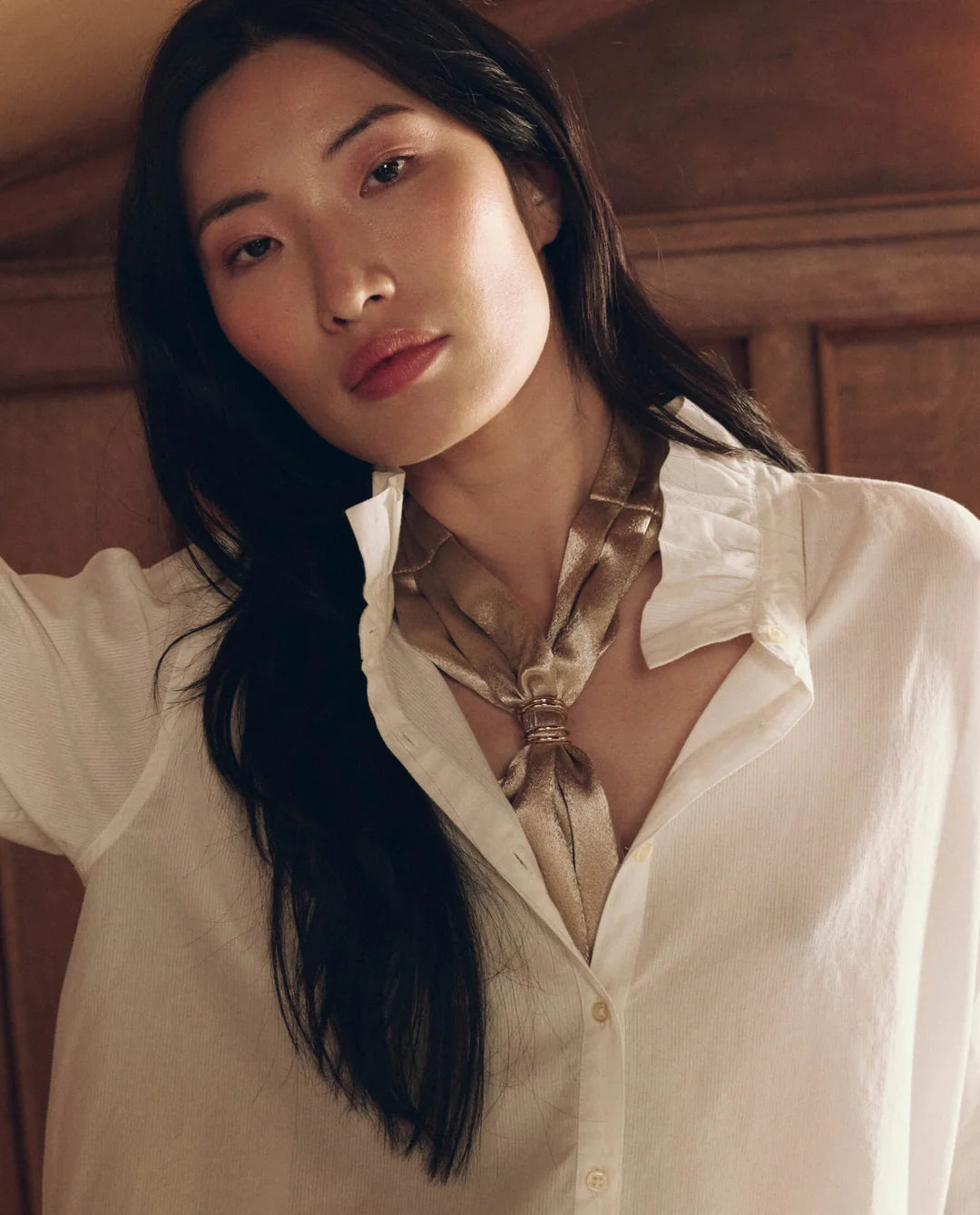 Shiny gold Pleated Neck Tie with metal ring, worn with a white button-down shirt by Bungalow Furniture &amp; Accessories.