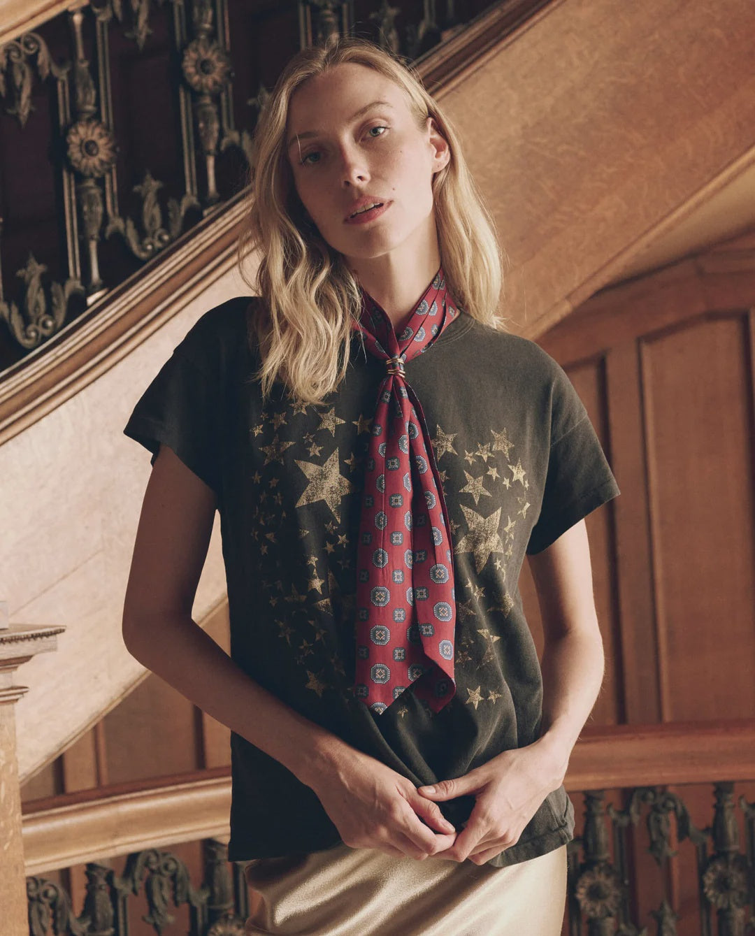 Red pleated vintage bow tie with a geometric pattern, worn over a gold star print grey t-shirt, Bungalow.