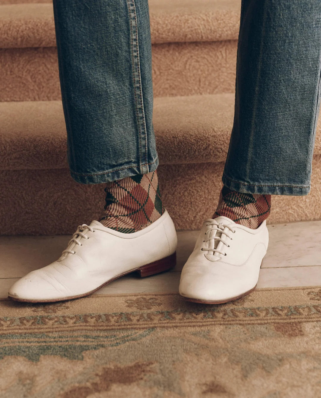 Brown and green vintage style argyle socks paired with blue jeans and white lace-up shoes, by Bungalow.