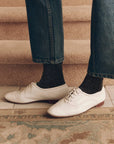 Black glittery Lurex socks with blue jeans and white leather lace-up shoes, by Bungalow Furniture & Accessories.