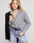 LS Boxy Crop in black and white stripe by THE SHIRT, styled with a jacket over the shoulder in a light, airy setting.