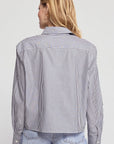The Shirt LS Boxy Crop top in white with light blue jeans, modern casual style against minimalist backdrop.