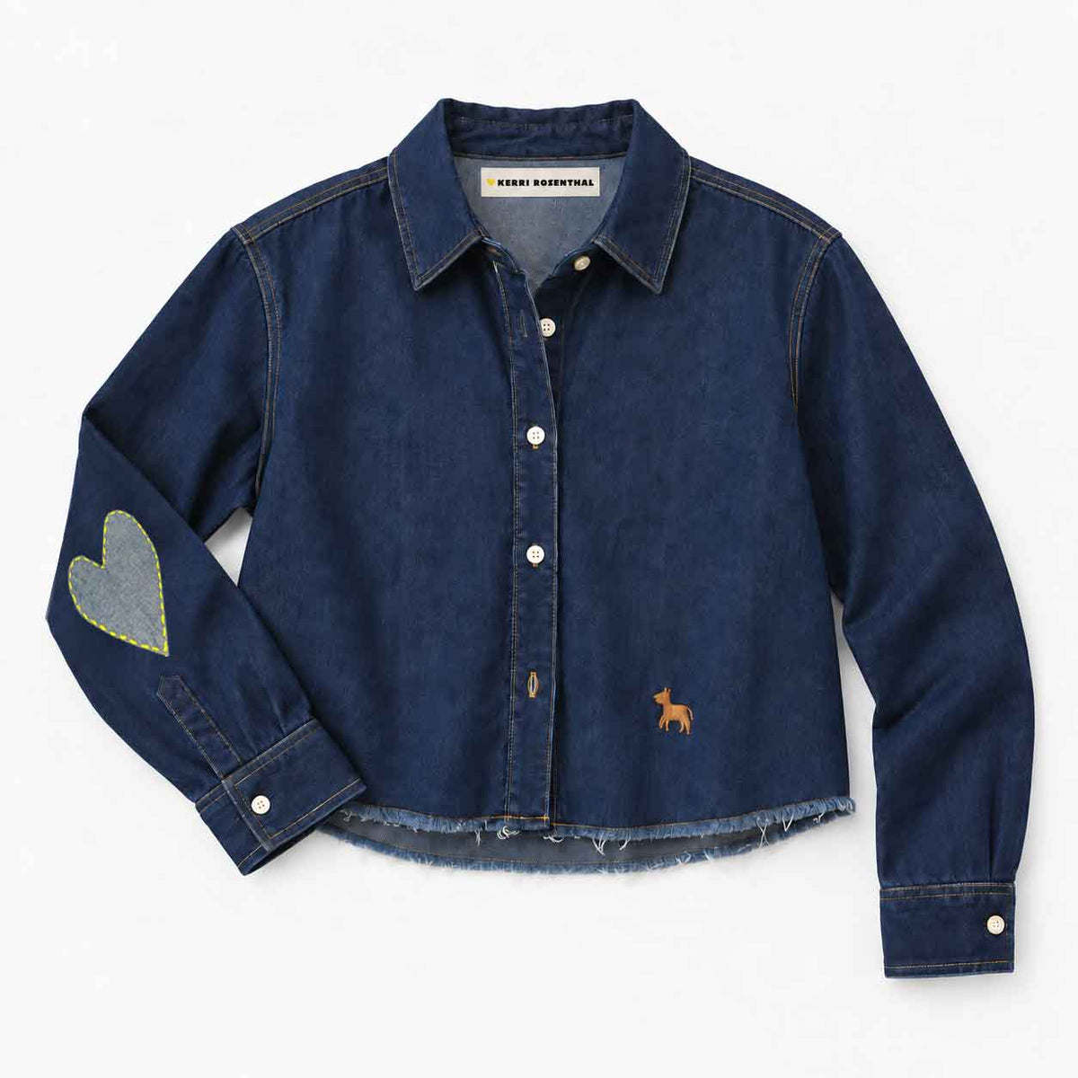 Dark denim button-down shirt by Kerri Rosenthal, featuring a frayed hem, heart elbow patches, and sleeve embroidery.