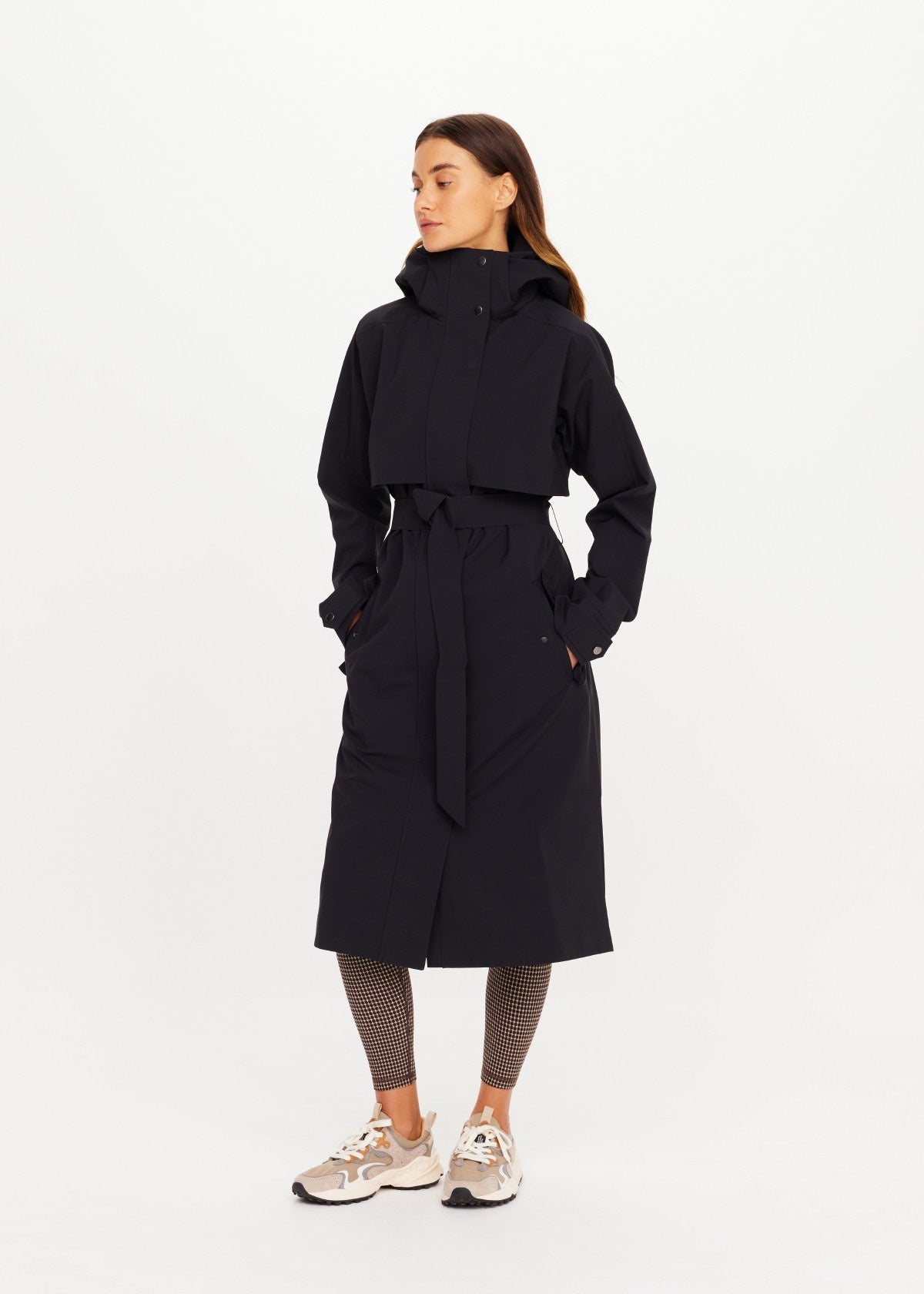 The Upside James hooded trench coat styled with patterned leggings and sneakers, casual modern look.