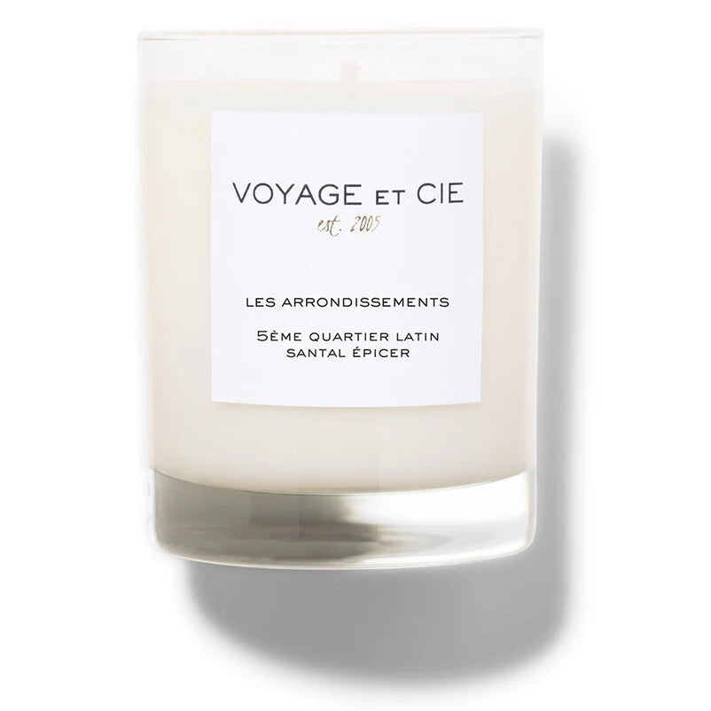 Discover elegance with the 14 OZ Classic Highball soy coconut candle by Voyage Et Cie in a clear glass jar, featuring a label "Les Arrondissements, 5ème Quartier Latin, Santal Épicé." Enjoy organic, sustainable luxury.