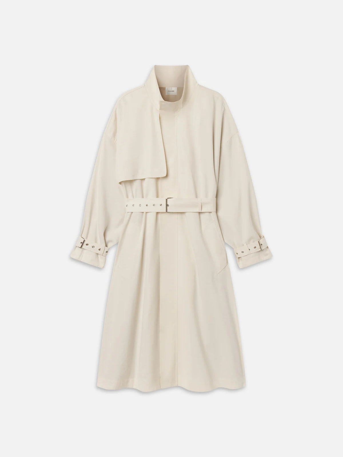 The Field Trench by FRAME is a cream-colored cotton coat featuring a belted waist, asymmetric wide lapel, buttoned cuffs, and two side pockets, shown against a plain white background.