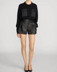 FRAME The Contrast Cashmere Cardi in soft knit, styled with black leather shorts and pointed-toe heels.
