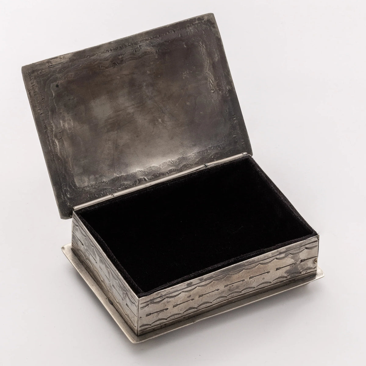 The 88-6 Silver Box w/ Longhorn by J Alexander Rustic Silver is a handcrafted rectangular box with a hinged lid, featuring a textured rustic silver exterior and smooth dark-lined interior. Shown open on a plain, light background.