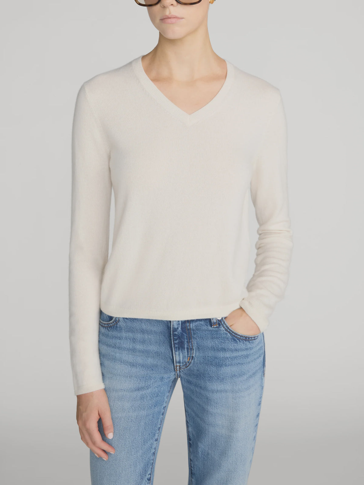 Cream Everyday Cashmere V-Neck Sweater paired with blue jeans.
