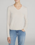 Cream Everyday Cashmere V-Neck Sweater paired with blue jeans.
