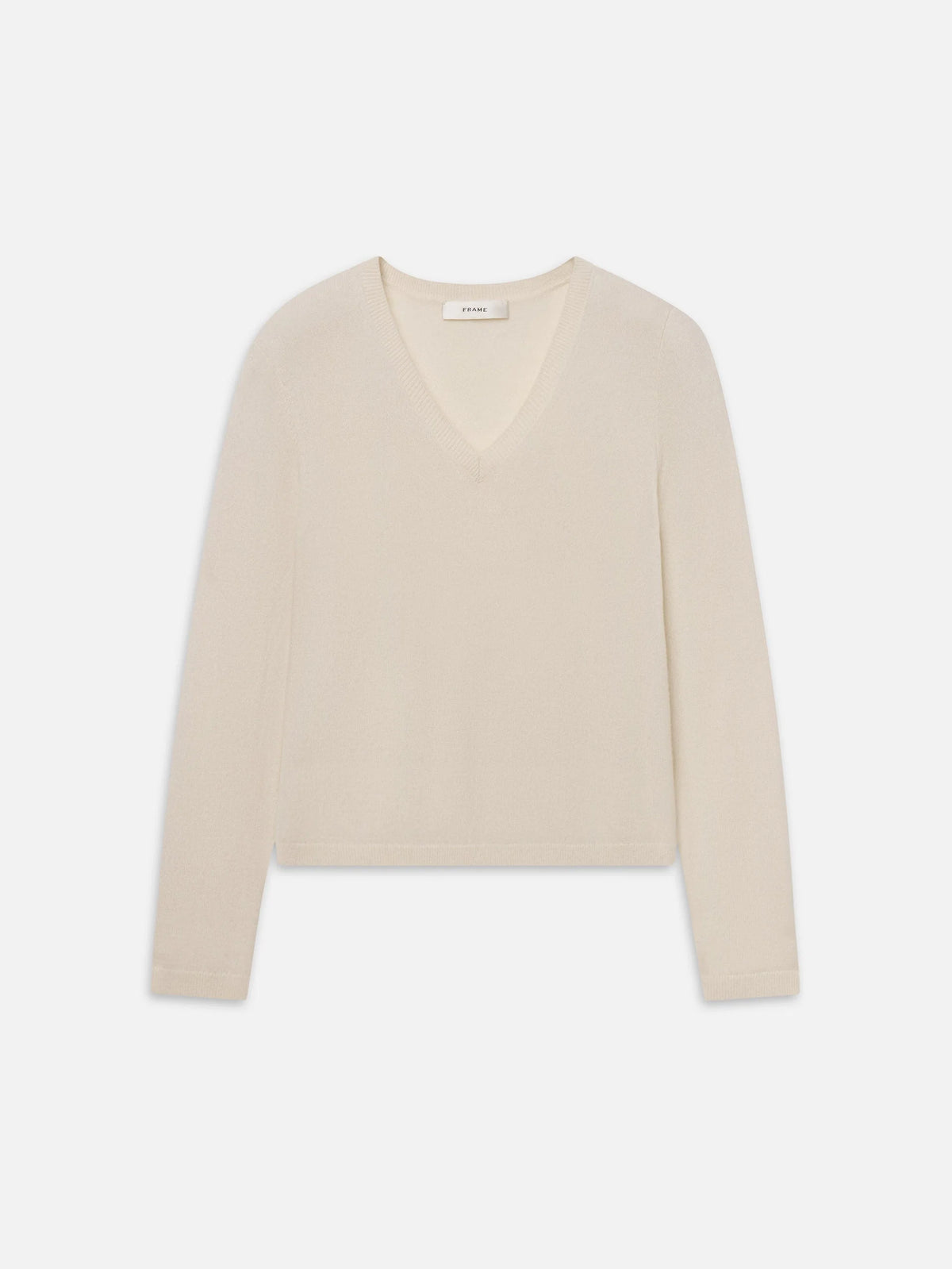 Cream cashmere V-neck sweater by FRAME with long sleeves.
