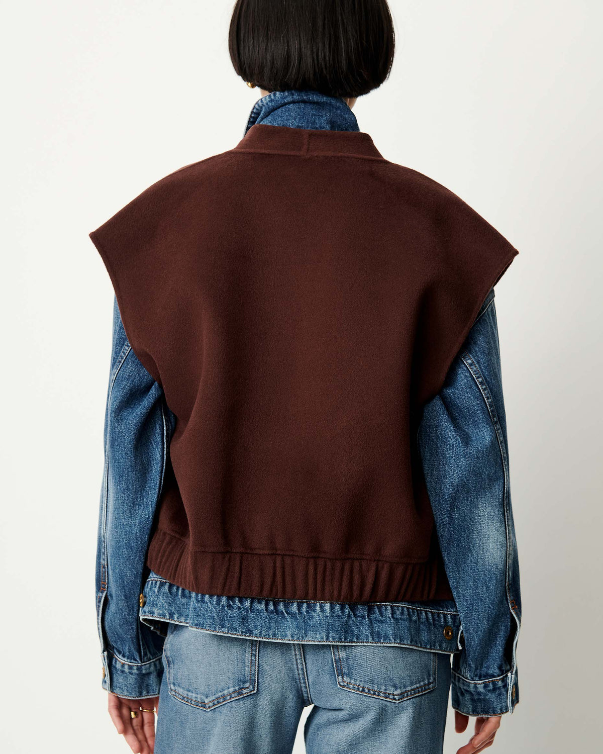 HELSPARK dark brown sleeveless shawl collar jacket layered over a denim jacket.